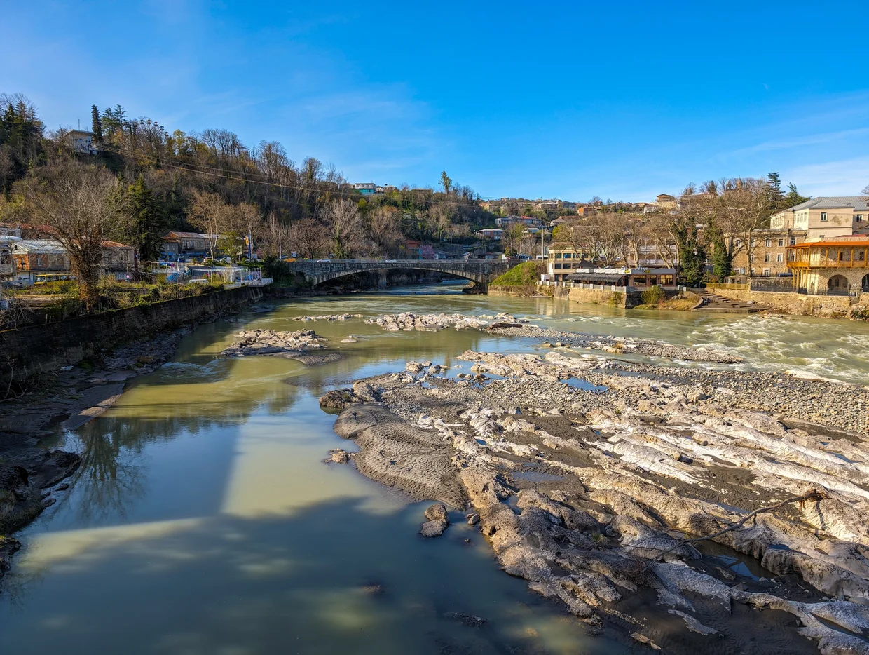 The Rioni river flowing through Kutaisi, stone bridge in background