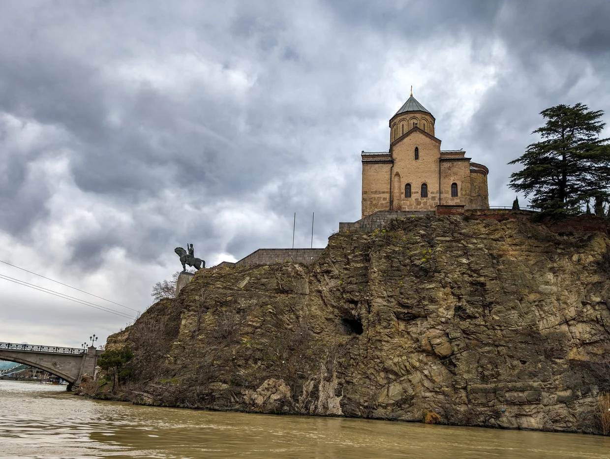 Metekhi Church on a cliff above the Mtkvari river, with the equestrian statue of King Vakhtang Gorgasali