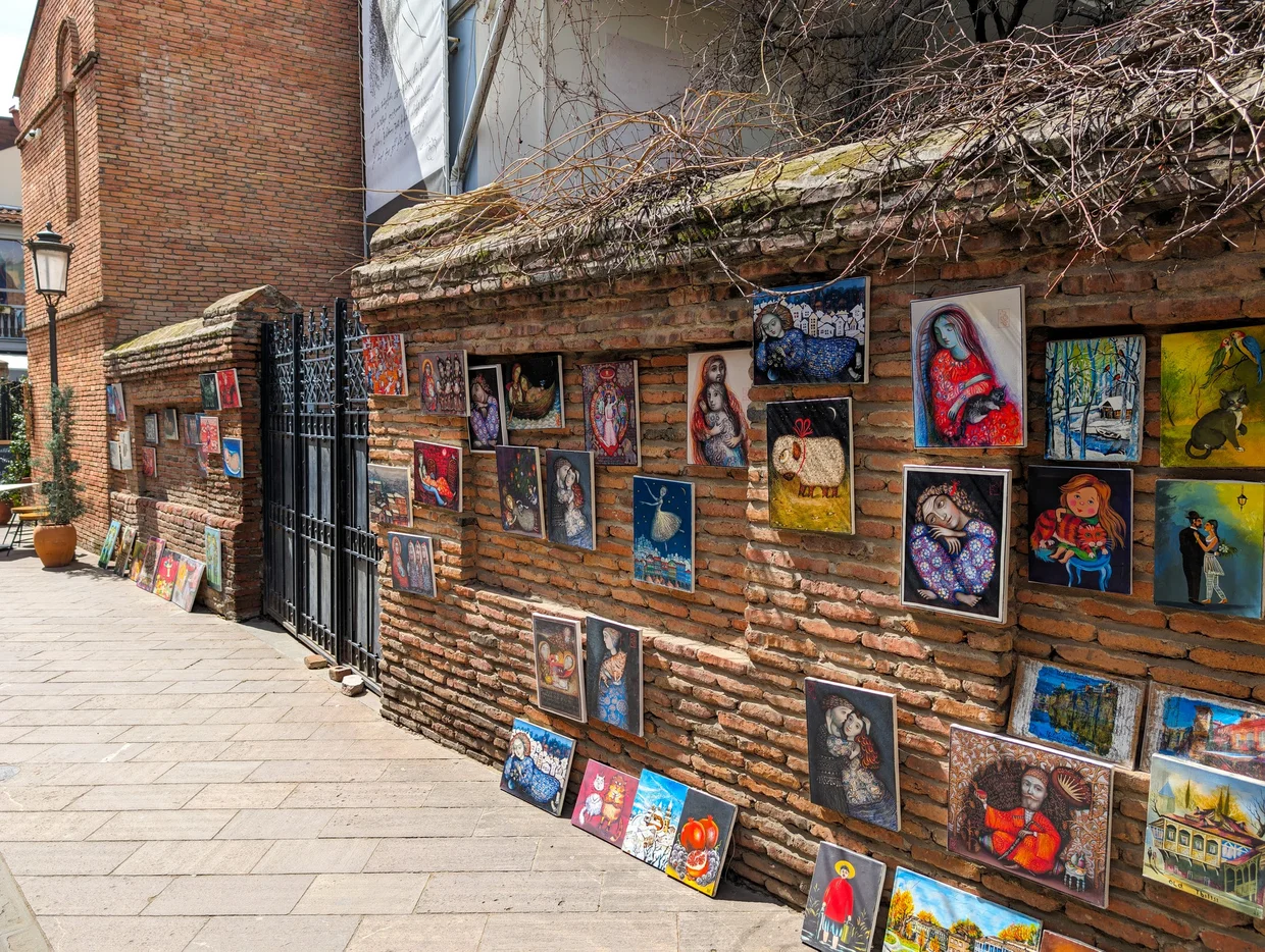 Paintings displayed on a brick wall, Old Tbilisi
