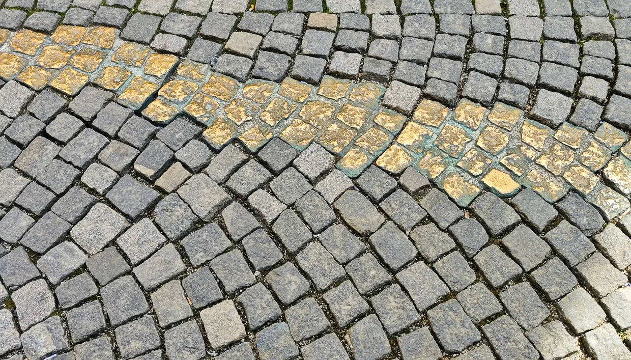 Golden cobblestones marking the Drückebergergasserl, the shirker's alley behind the Theatinerkirche
