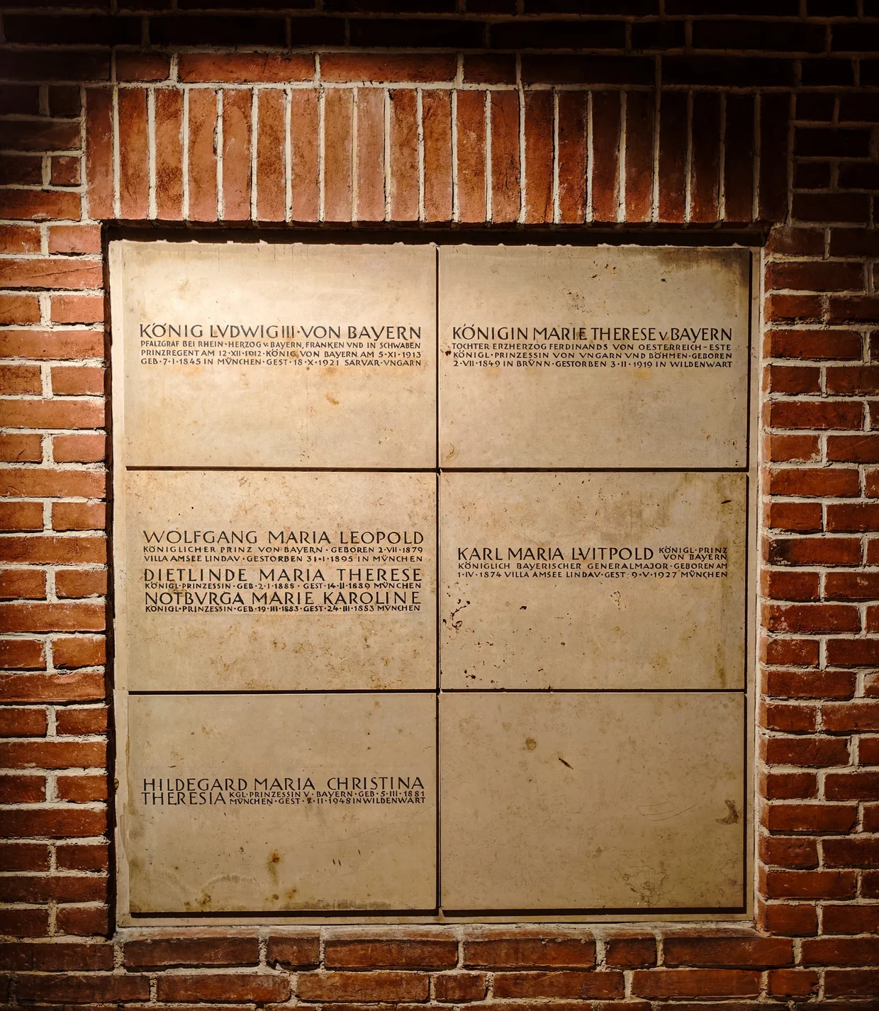 Inscribed stone slabs in the Wittelsbach crypt naming King Ludwig III, Queen Marie Therese, and the princes and princesses