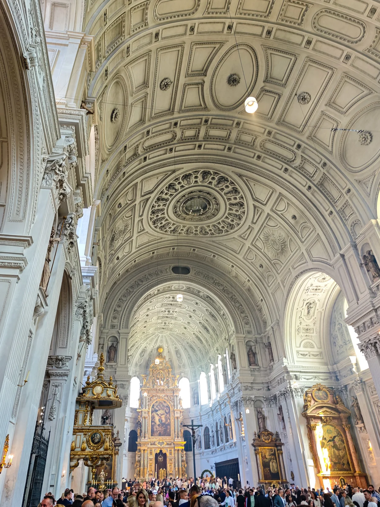 Interior of St. Michael with white barrel vault and golden high altar