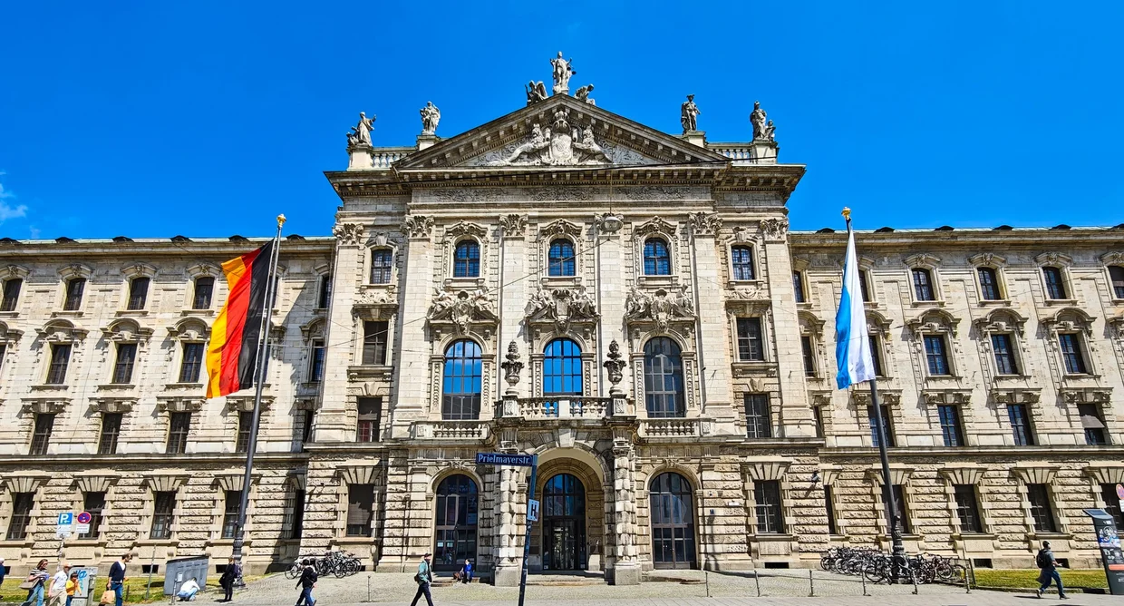 The Justizpalast at Karlsplatz / Stachus, neo-Baroque domed facade with German and Bavarian flags