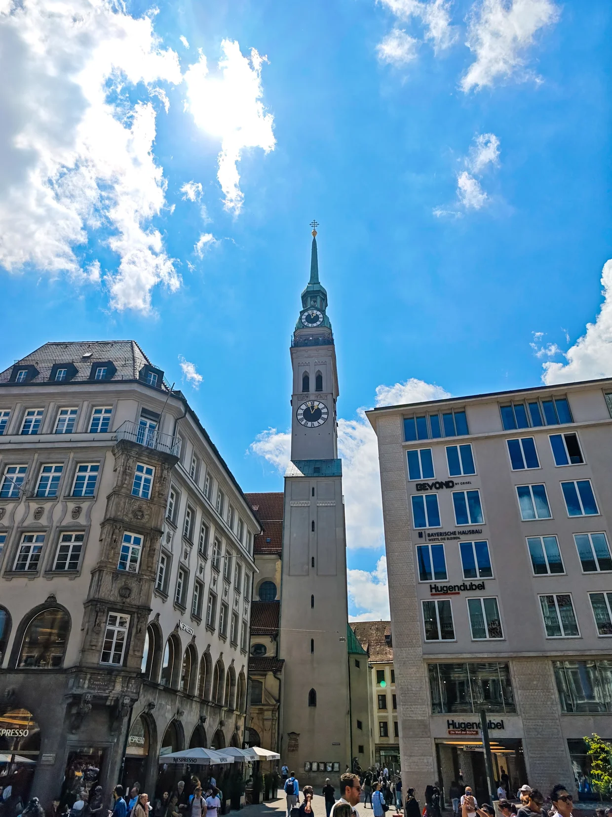 Alter Peter church tower seen from Marienplatz, slim and tall against blue sky