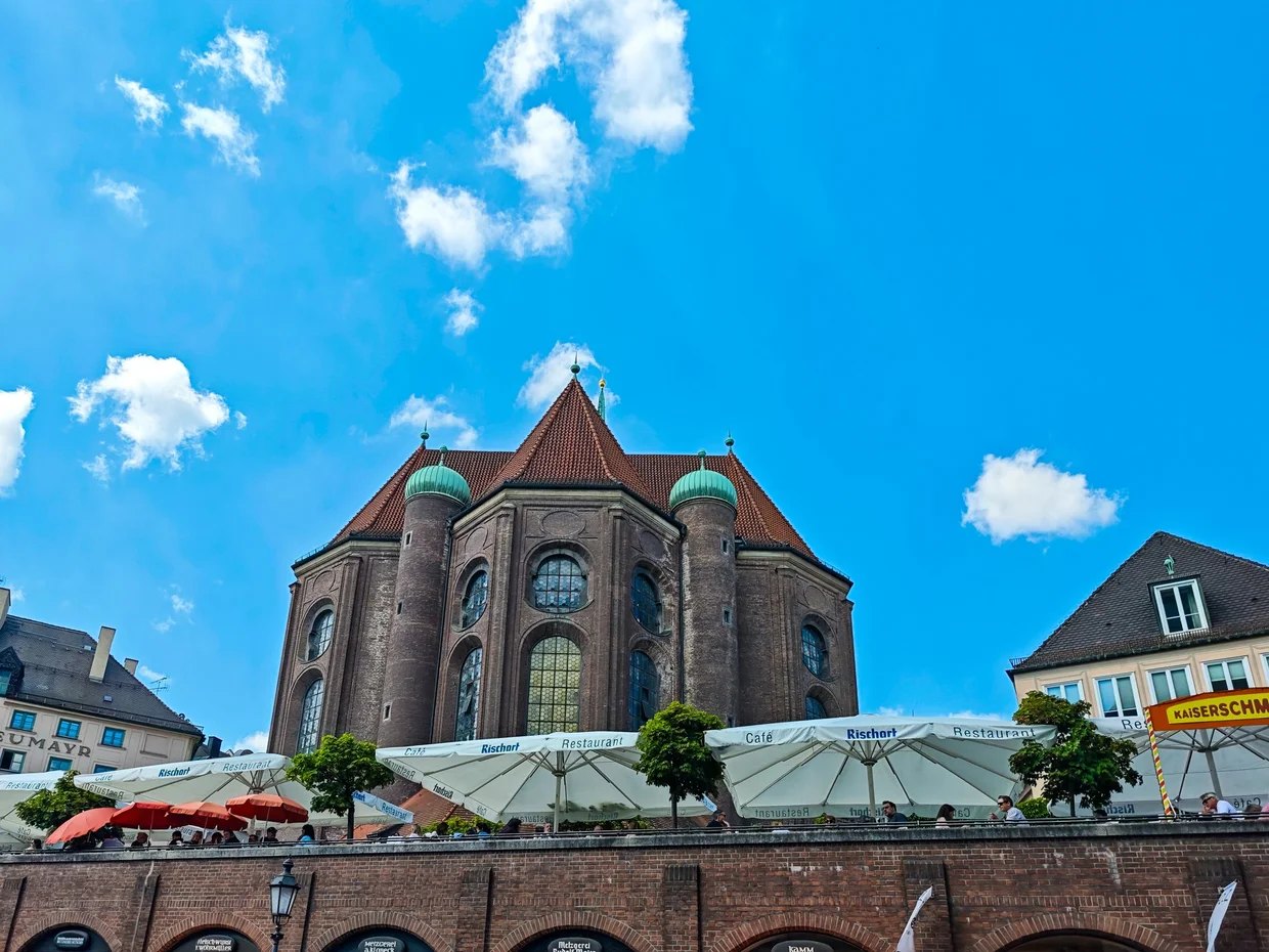 Heilig-Geist-Kirche apse from the Viktualienmarkt side with cafe umbrellas in front