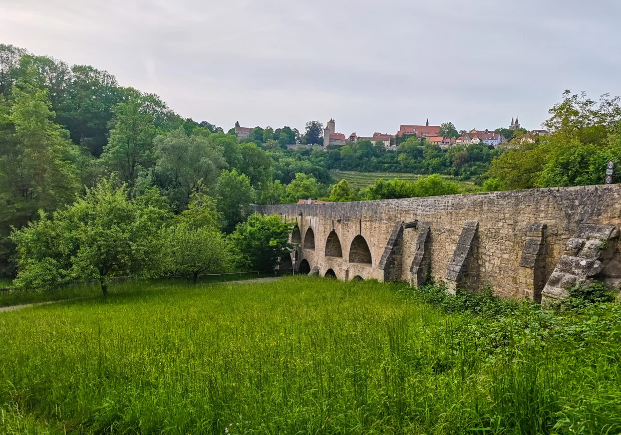The Doppelbruecke arches with Rothenburg perched on the hill behind