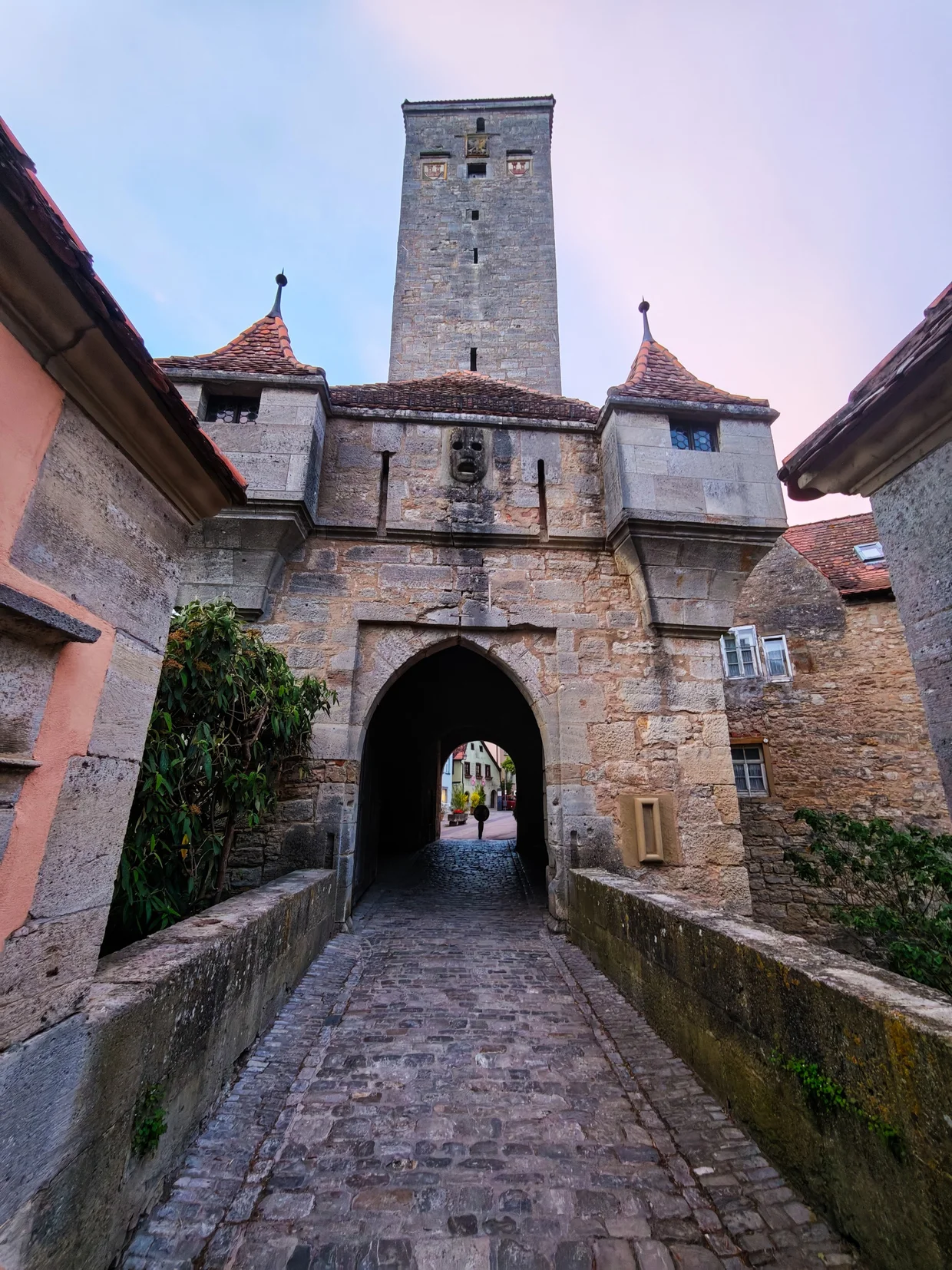 The Burgtor at twilight, its cobbled ramp empty and the sky gone pink