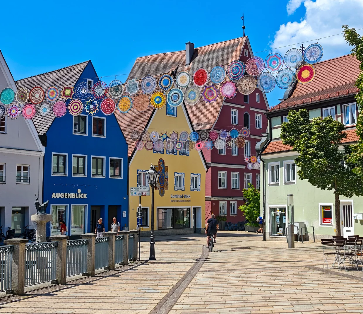 Hundreds of colourful crocheted discs strung on lines above the Reichsstrasse