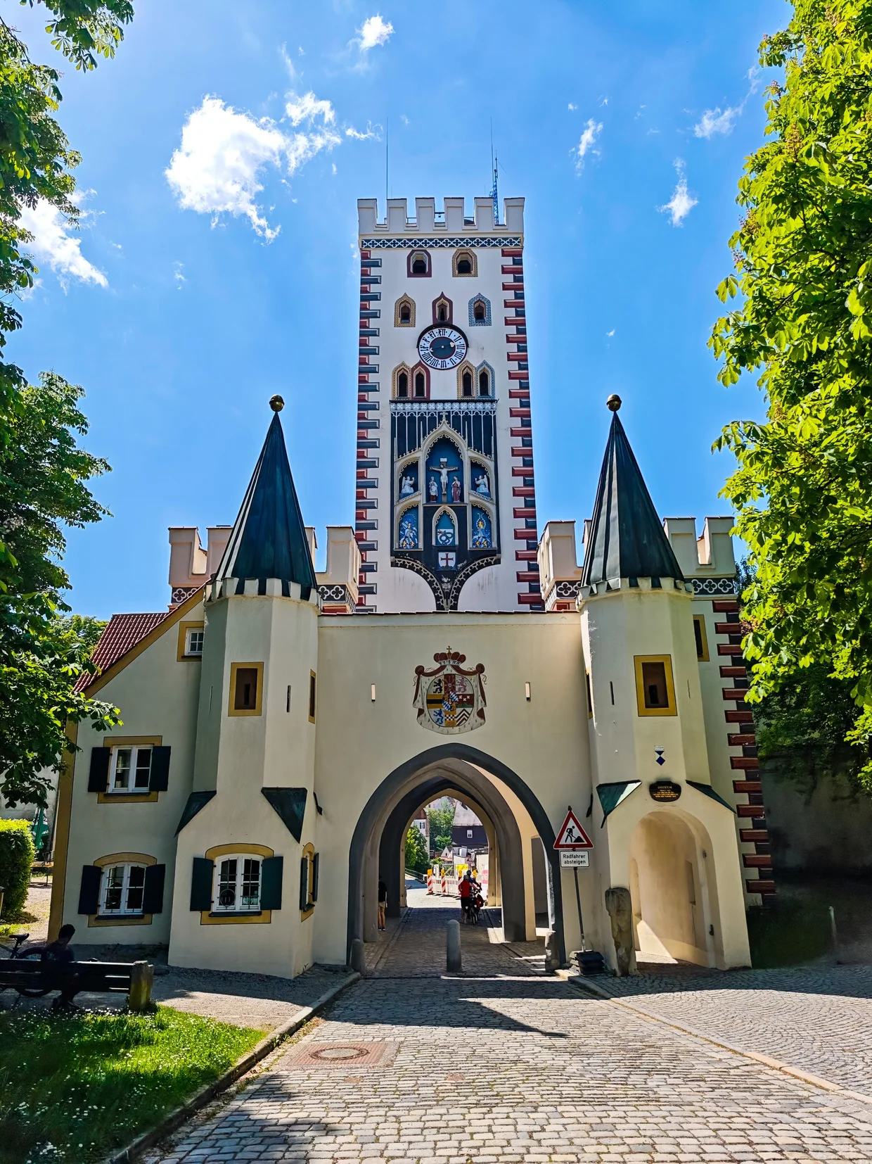 The Bayertor, Landsberg's tall painted Gothic gate tower, framed by green trees
