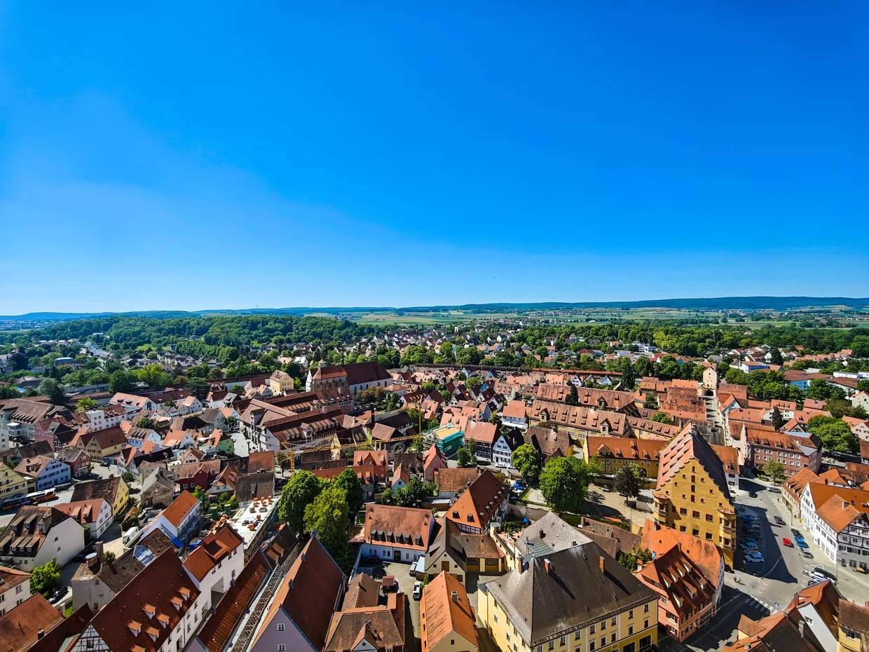 Nordlingen's red roofs packed inside its wall with the crater rim on the horizon
