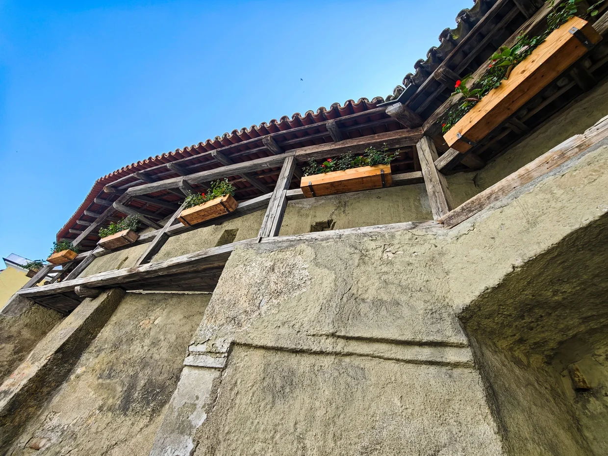 Looking up at timber-supported lofts on the wall