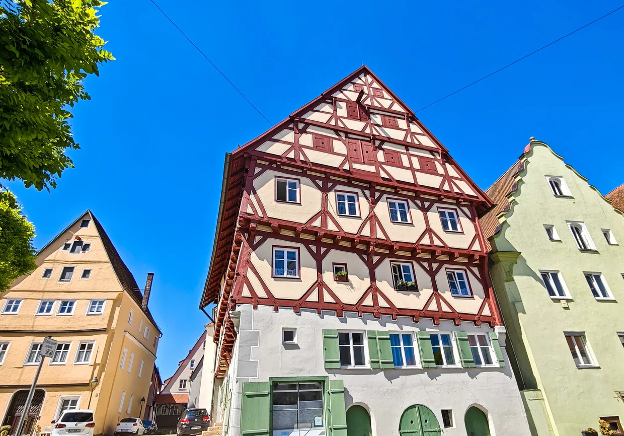 A tall red-beamed half-timbered townhouse