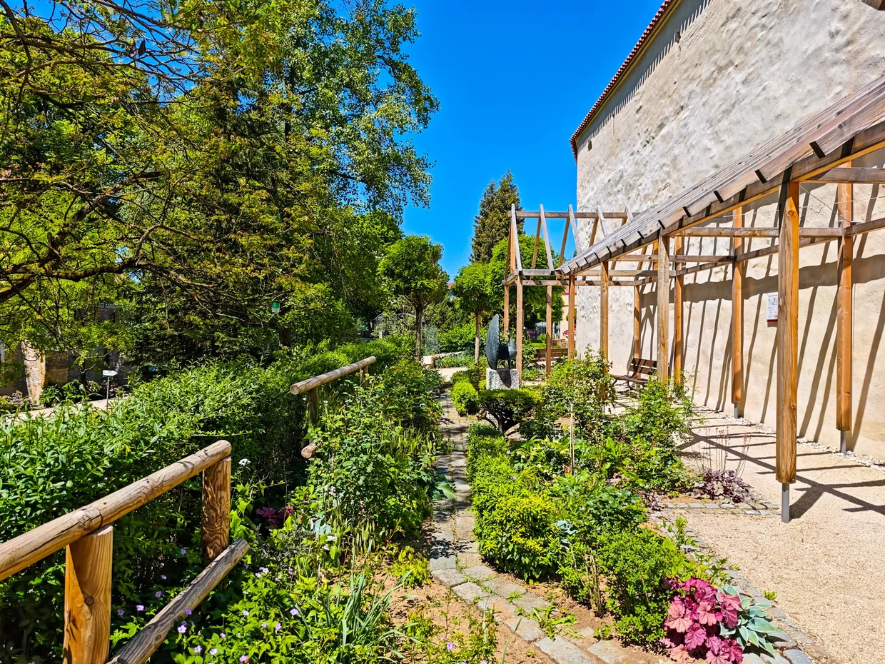 Walled monastery garden with raised herb beds
