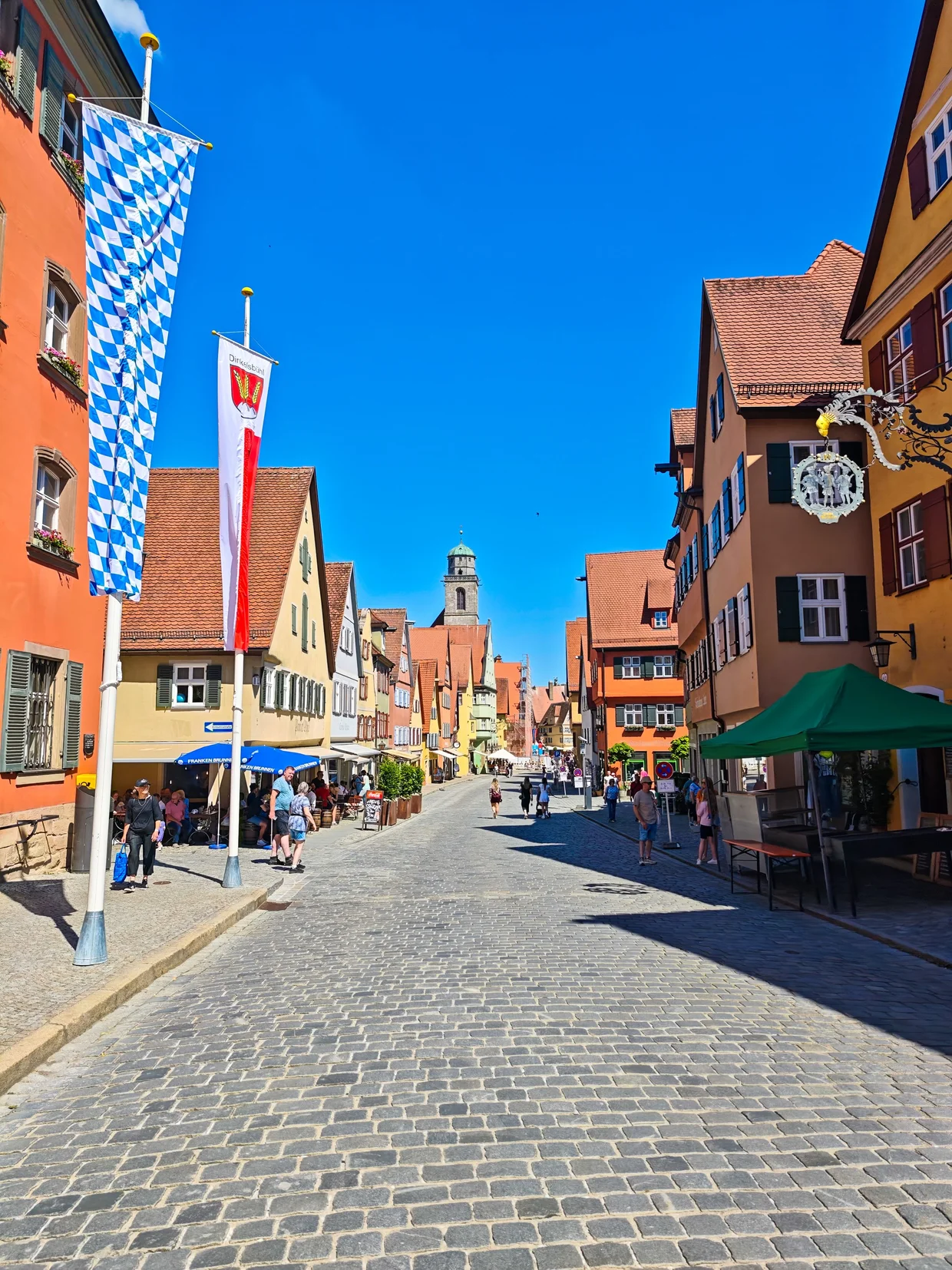 Cobbled main street with Bavarian flag, Munster tower behind