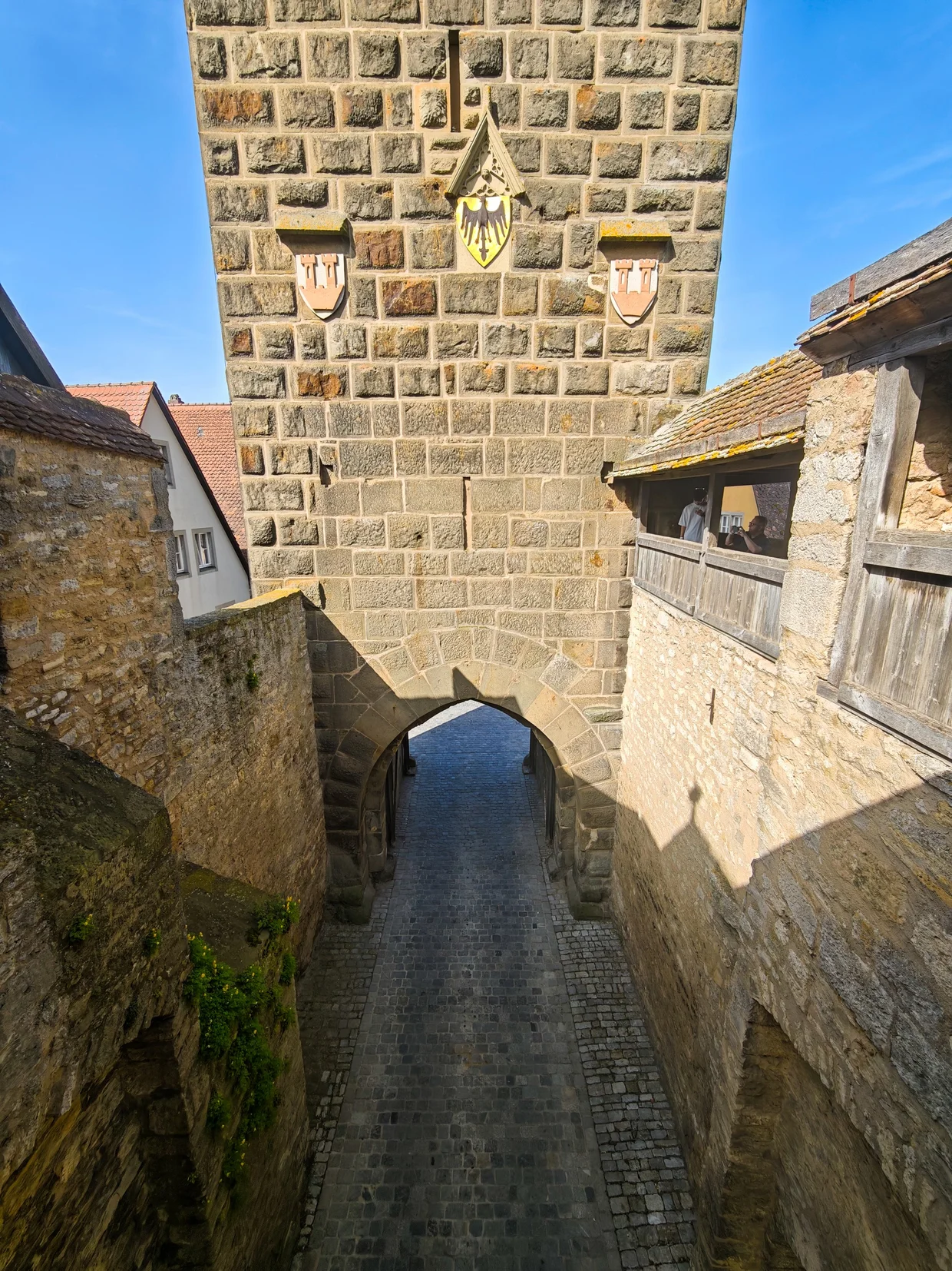 Festival reenactors below a gate banner