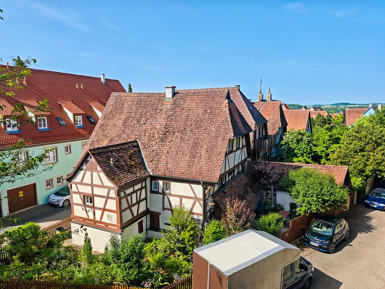 Half-timbered house with cobbled lane curling up to a tower
