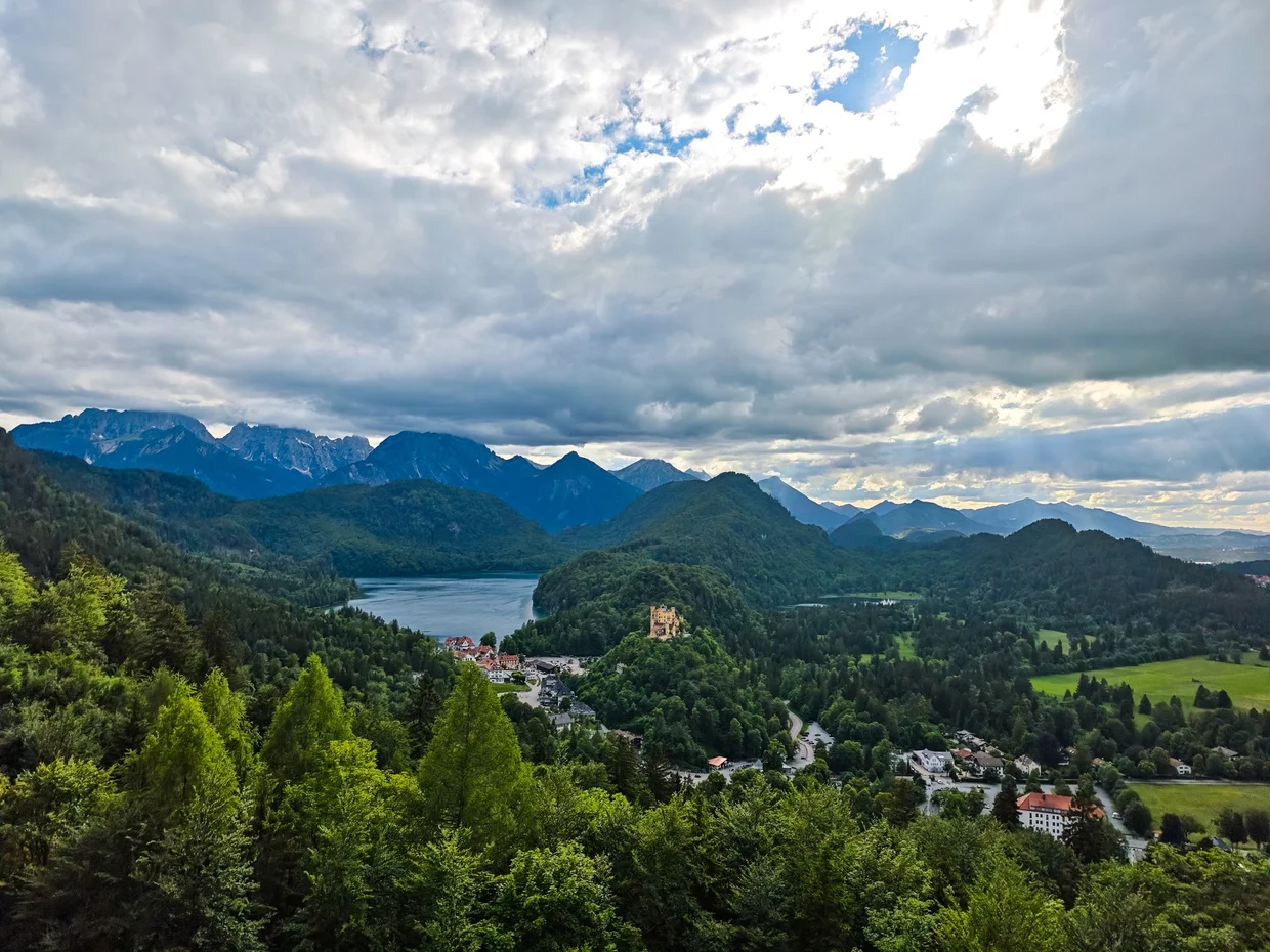 A wide evening panorama over the Alpsee, Hohenschwangau and the mountains