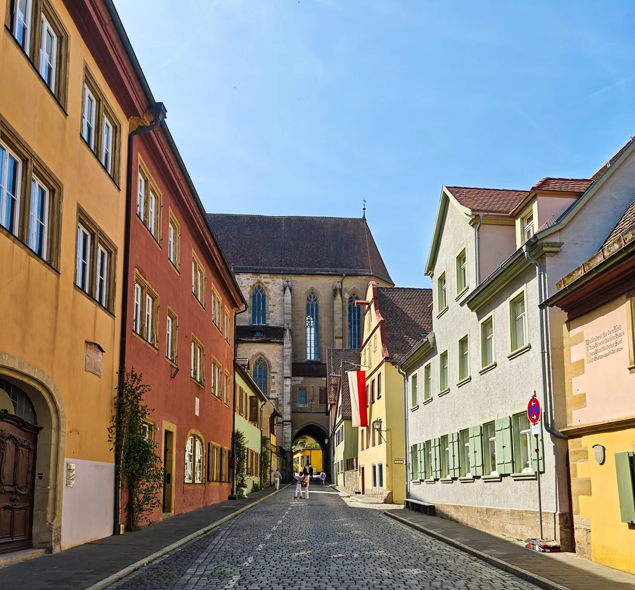 Colorful cobbled street with red shutters