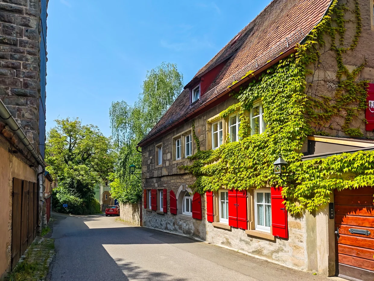 A half-timbered house with crest banner