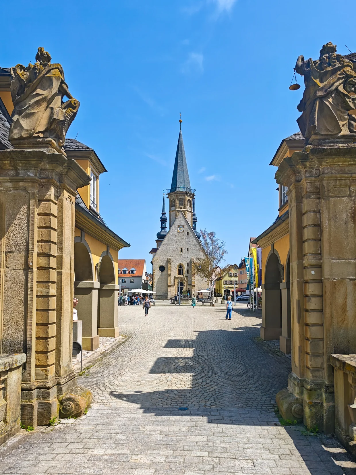 Approach to Marktplatz framed by ornate gate pillars