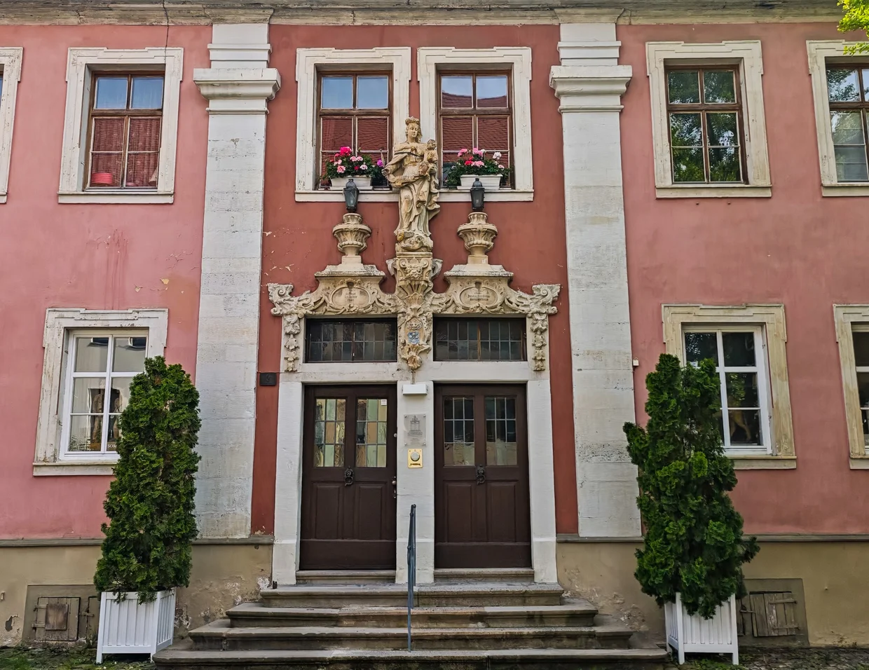 Pink Schloss wing door with sculpted Madonna above