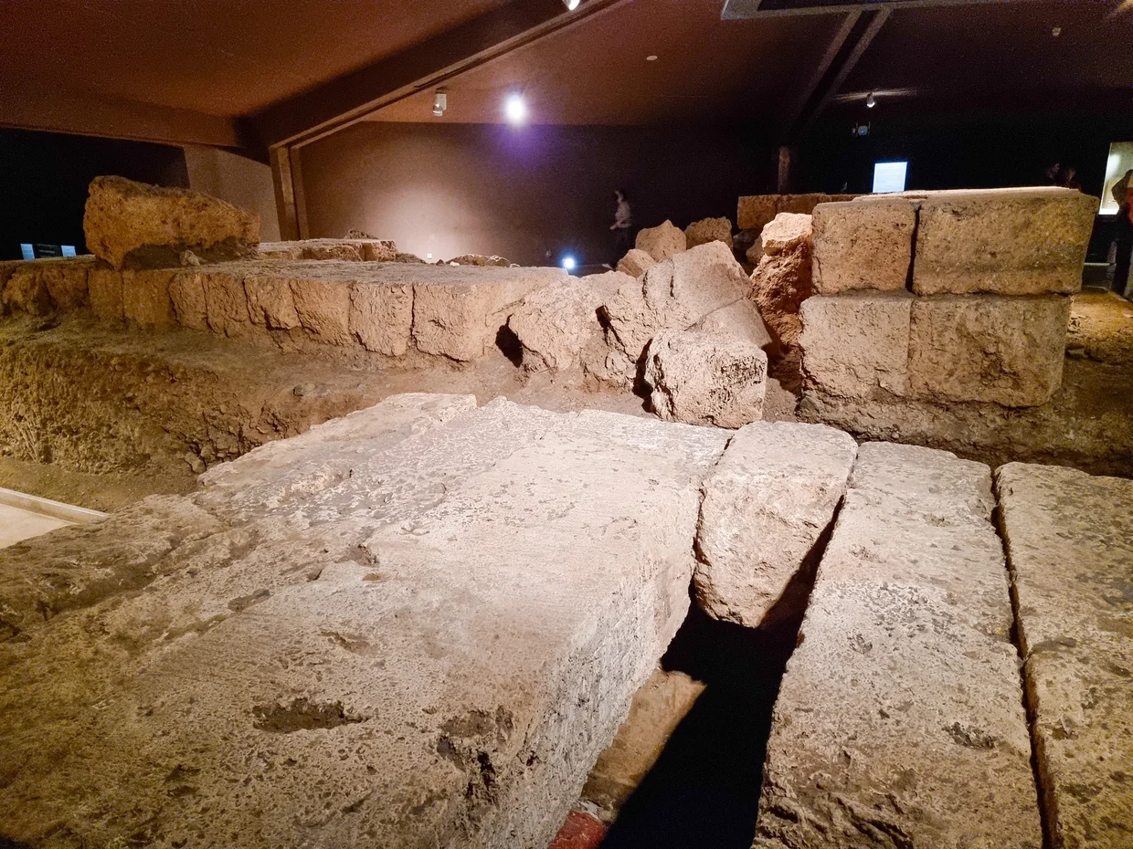 Interior view of stone tomb blocks under museum lighting
