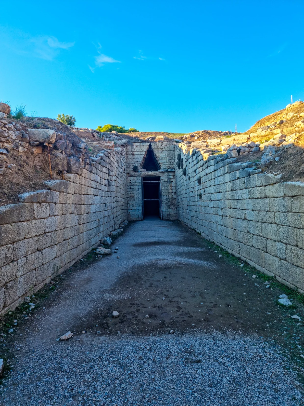 Long stone corridor (dromos) leading toward the Treasury of Atreus