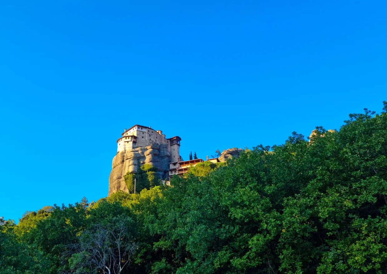 Small monastery on a rock pillar in golden evening light