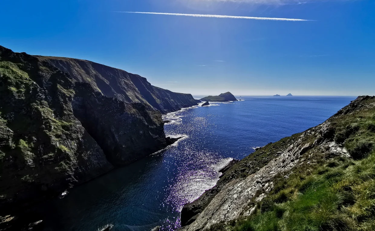 The Skellig Islands on the horizon seen from the Kerry Cliffs near Portmagee