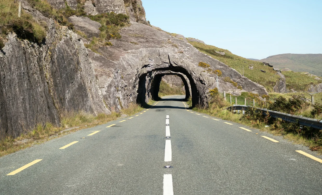 A road tunnel cut straight through rock on a Kerry mountain pass