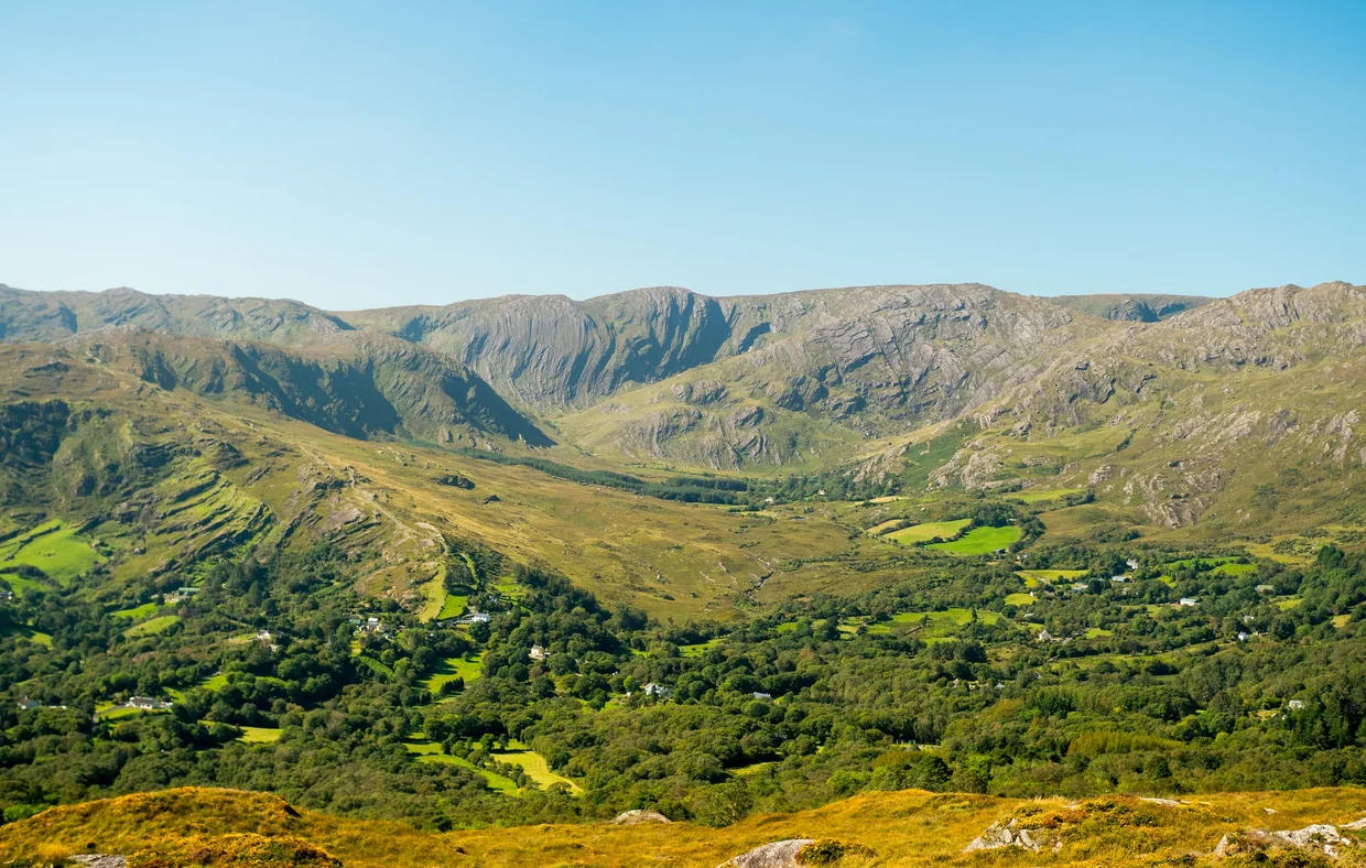 A green mountain valley with rocky ridges on the route between Kerry and West Cork
