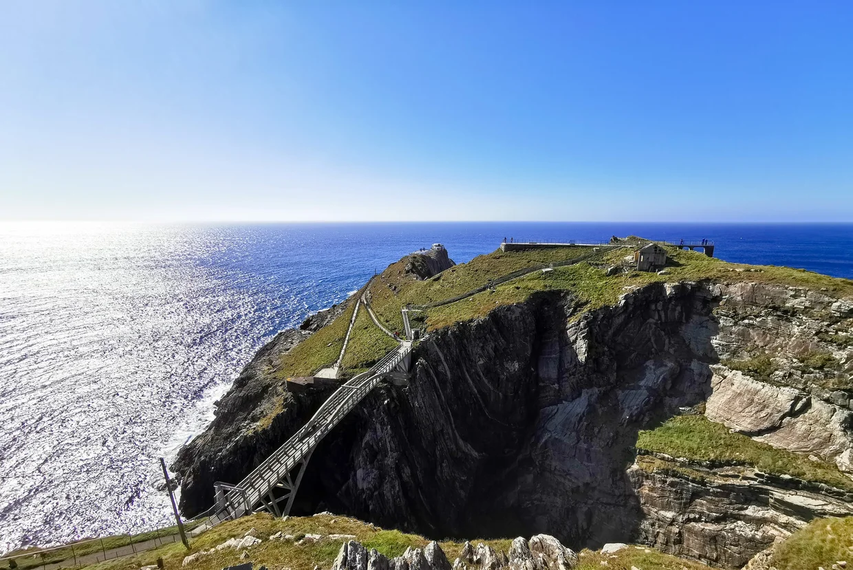 Mizen Head signal station on a clifftop headland with the path winding out above the Atlantic