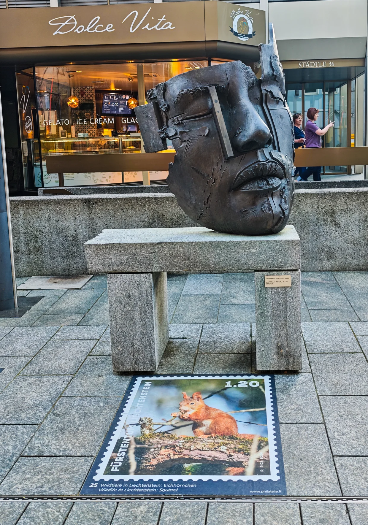 Bronze face mask sculpture at the gelato shop