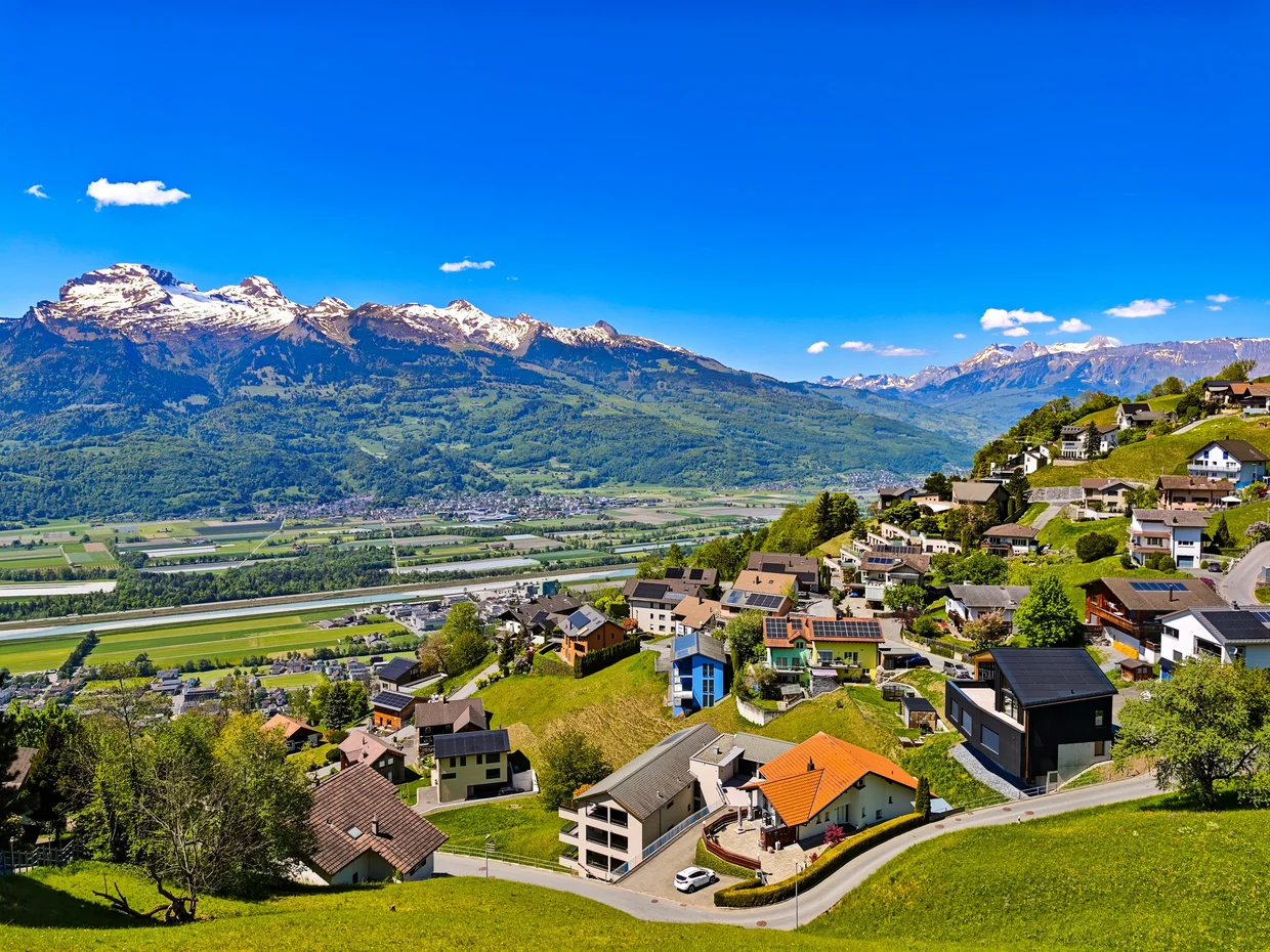 Triesenberg houses spilling down the hillside with the Rhine valley below
