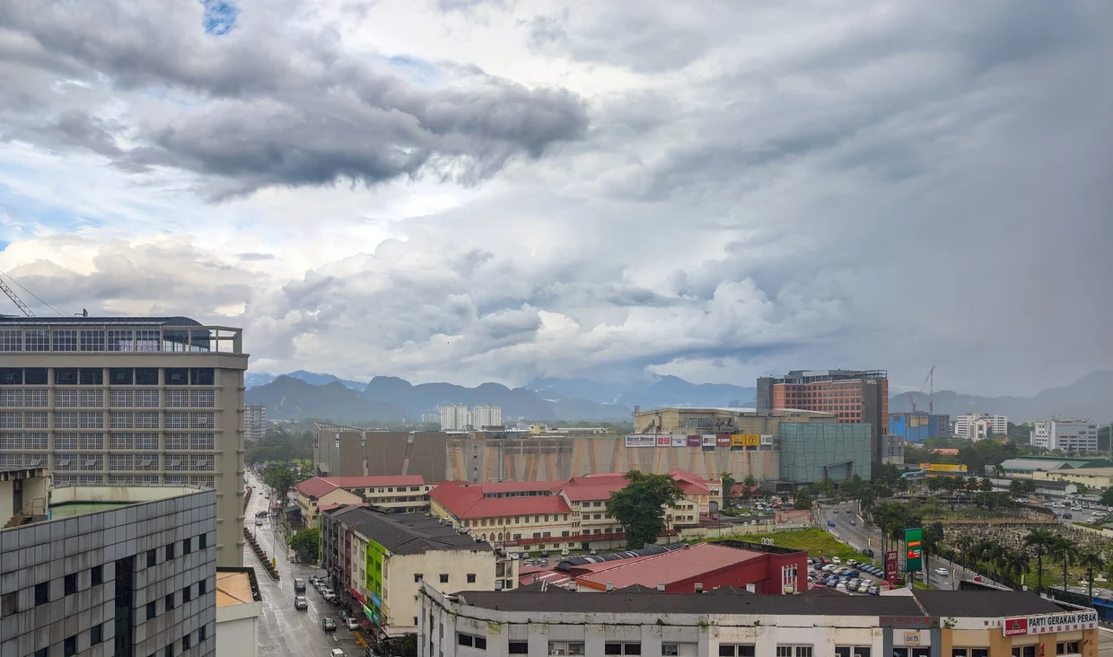 Ipoh skyline from a balcony, with mountains poking through
