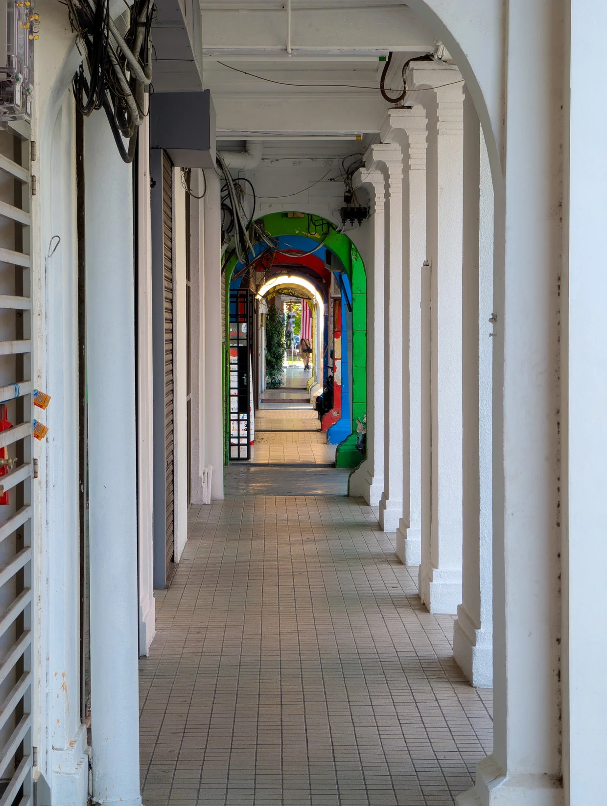 Looking down a long colonnade toward color