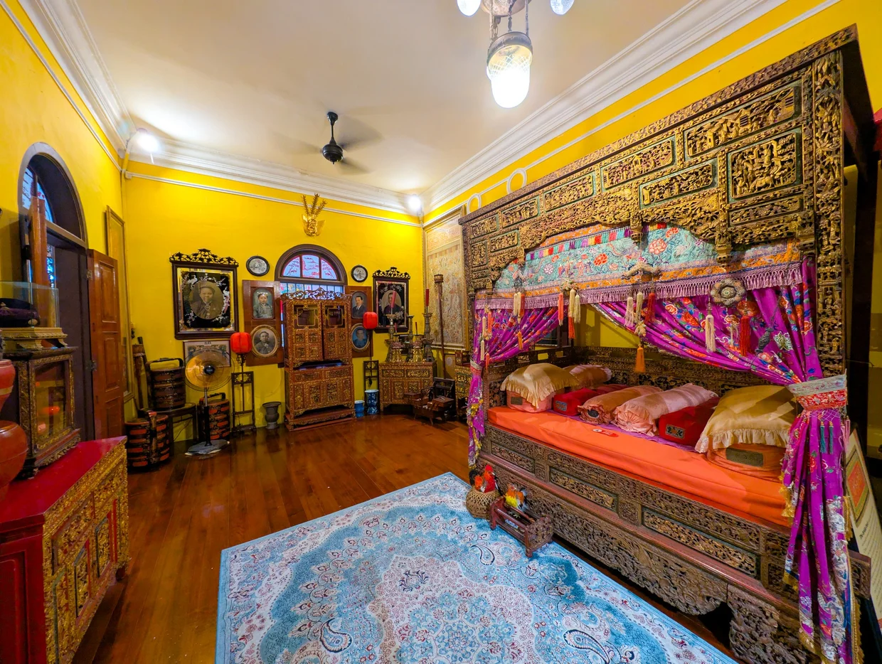 Yellow bedroom with Indian/Sikh-style carved bed