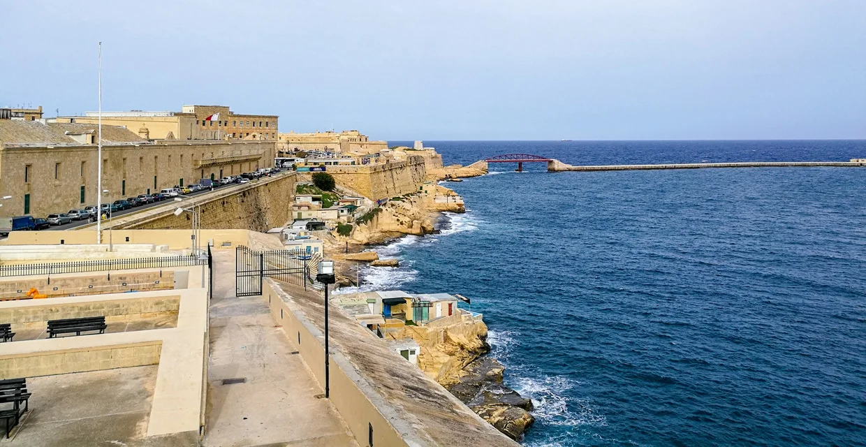 View across Grand Harbour at sunset with fortification walls