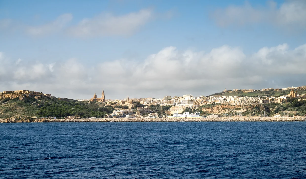 Mgarr harbour with church spires on the hillside