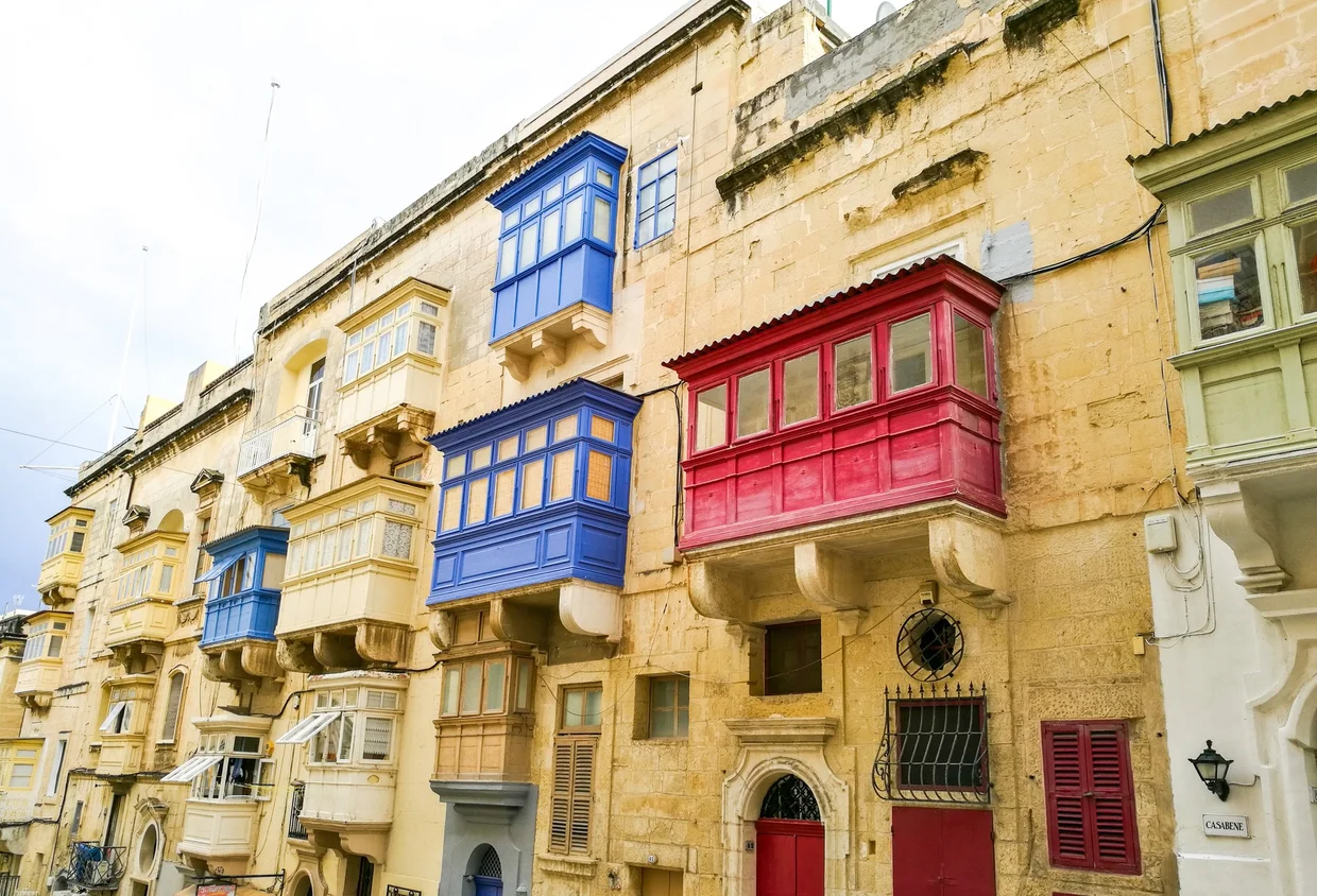 Close-up of the iconic enclosed wooden balconies in blue and red