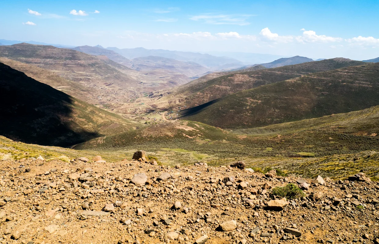 Vast barren Lesotho highland landscape with mountains stretching to the horizon
