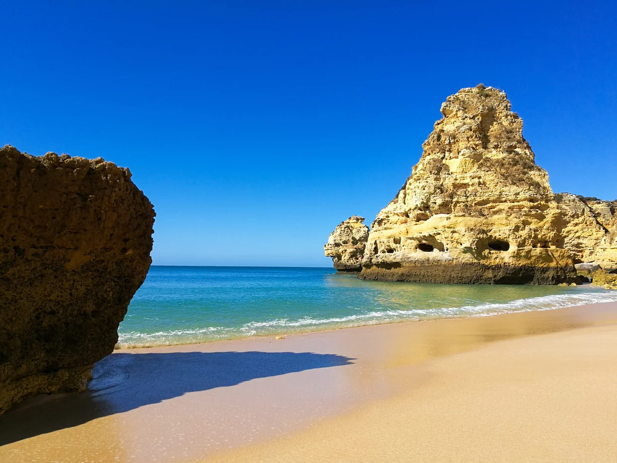 Golden rock formations on the beach