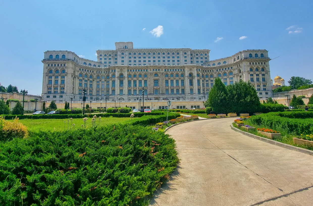 The vast facade of the Palace of the Parliament from its gardens