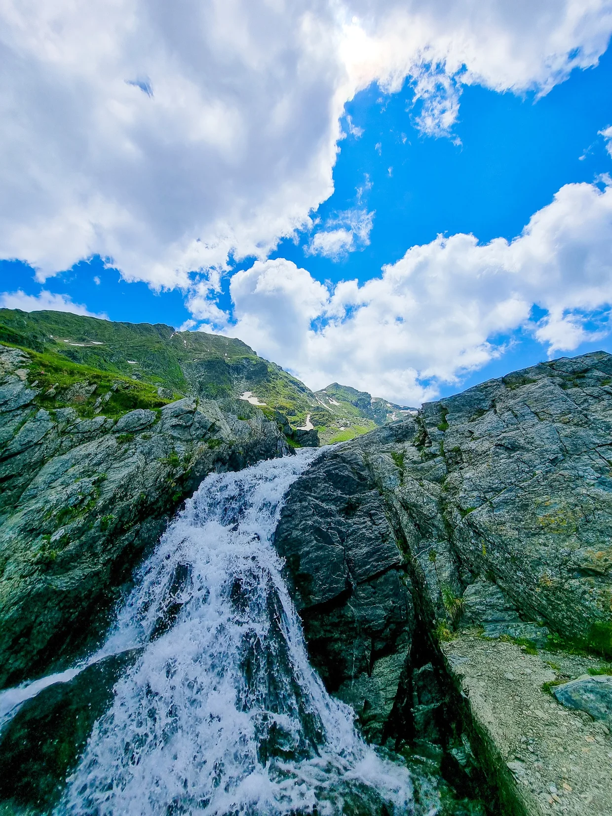 A tall waterfall dropping down dark rock