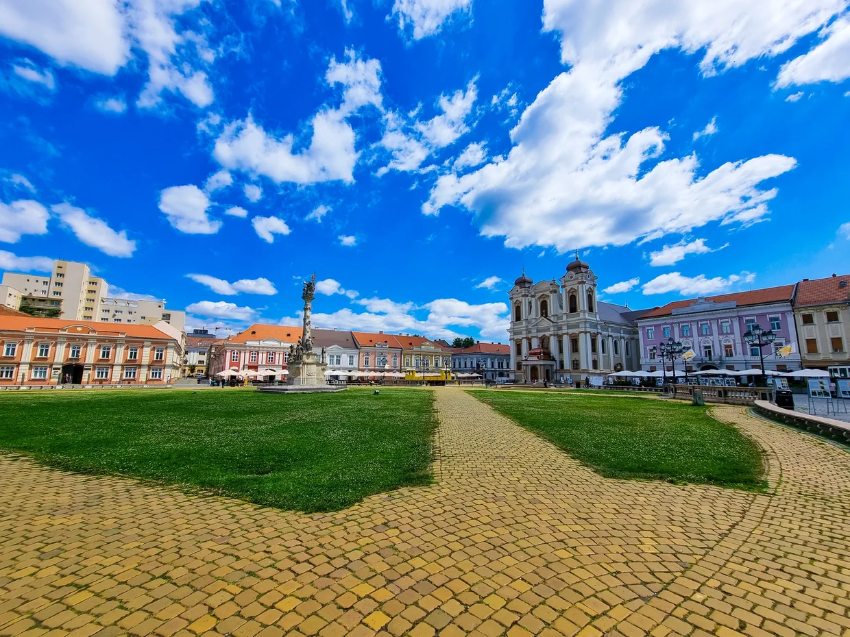 A cobbled square with restored facades and open pedestrian space