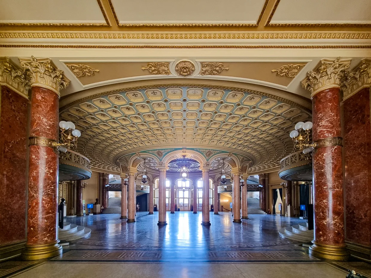 A marble columned hall inside the Athenaeum
