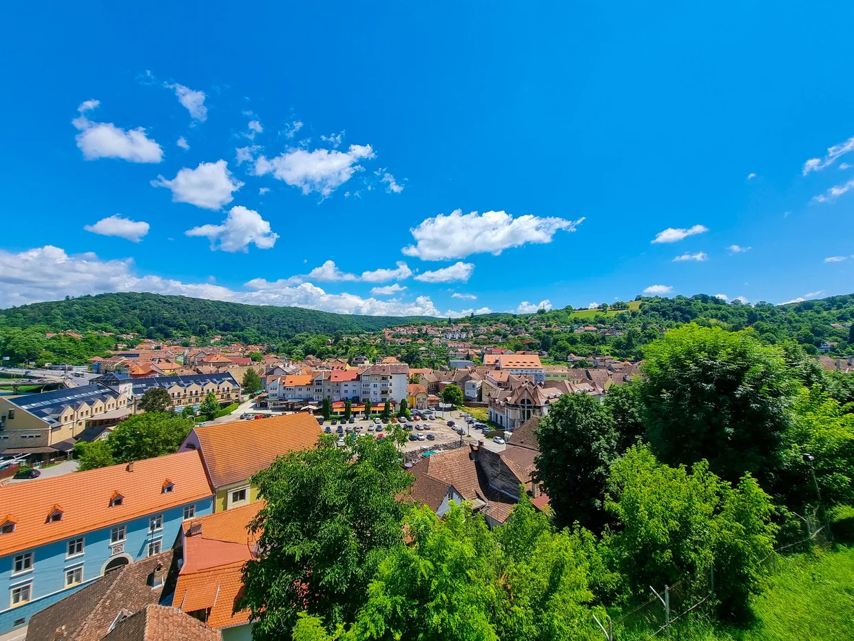 Rooftops of Sighisoara and surrounding green hills from the citadel