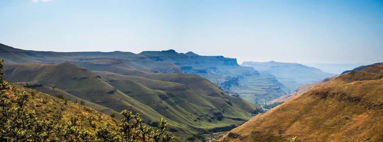 The Drakensberg valley, green slopes and flat-topped mountains