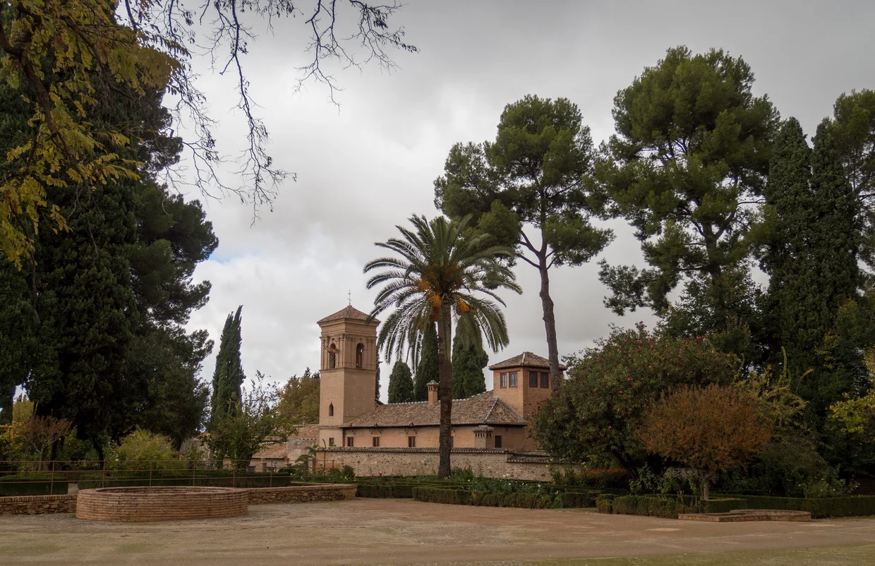 The Alhambra grounds with palm tree and church tower