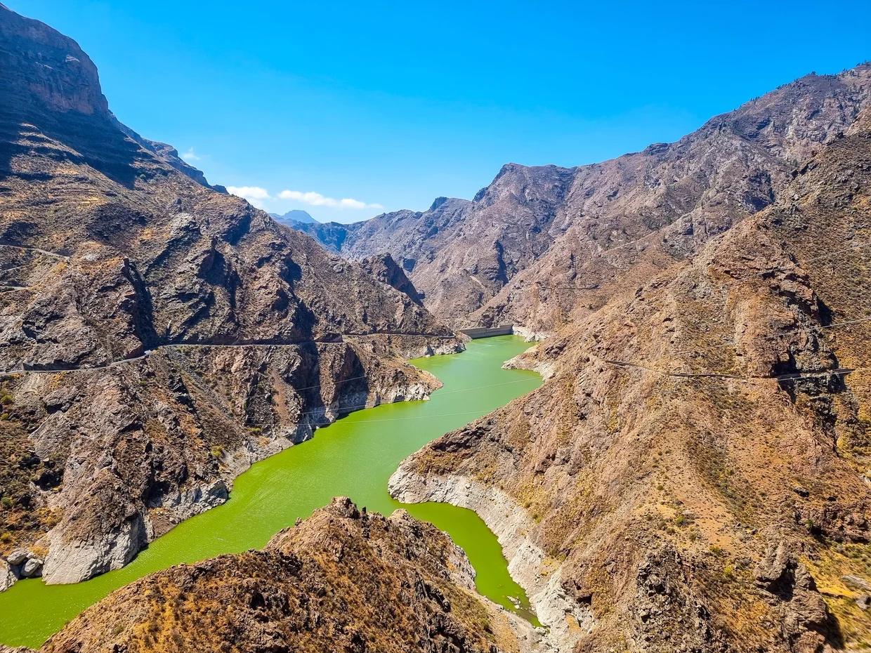 Dramatic canyon with emerald green reservoir